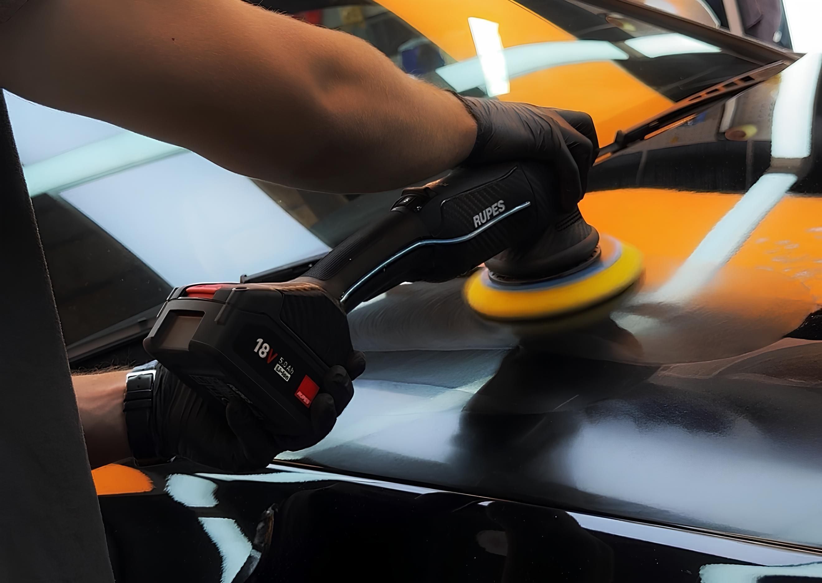 polishing a black car